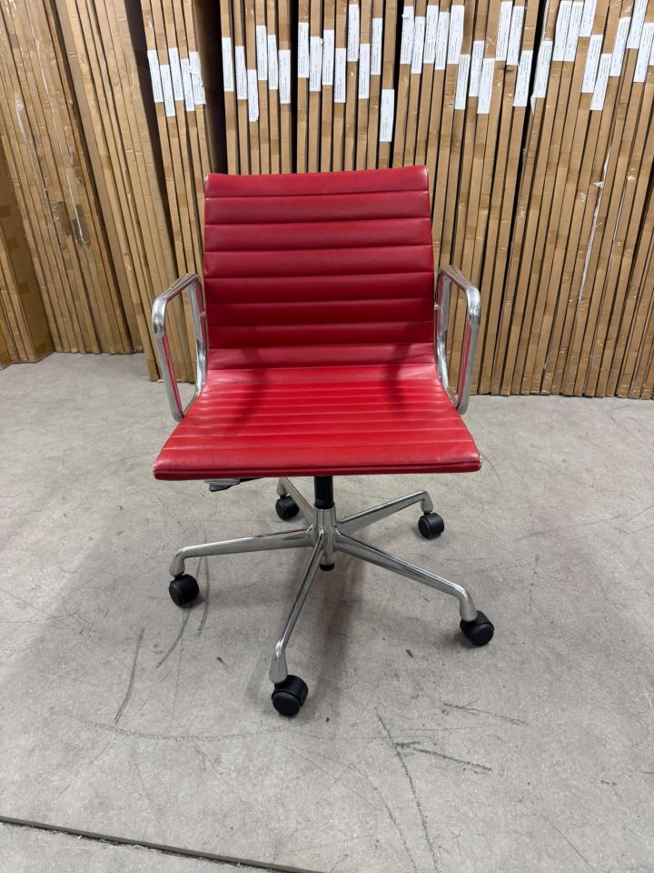 Vitra Eames Aluminium chair EA117 red leather front view showing the chrome five-star base