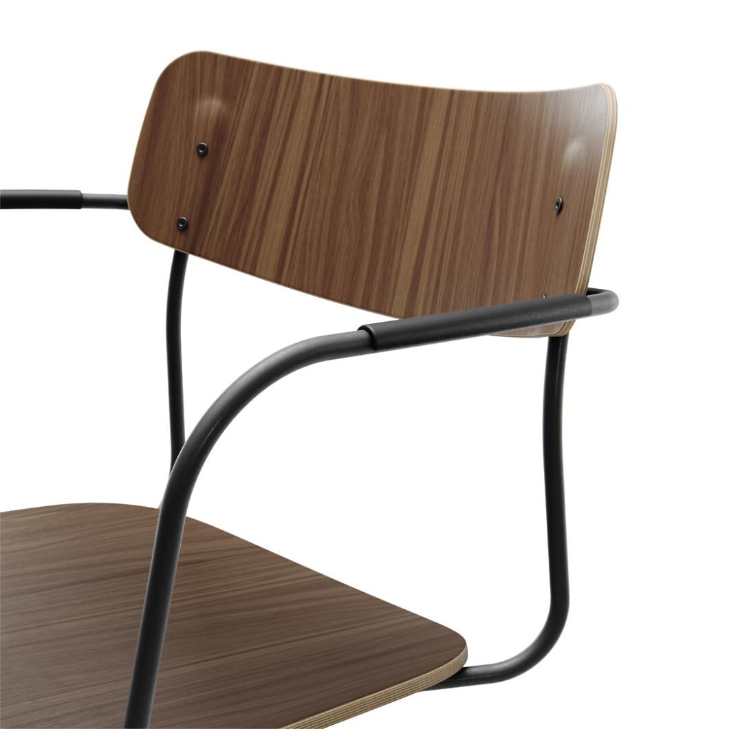 Martela Ella chair in walnut, close-up of the moulded back, plywood edge and black tubular arm