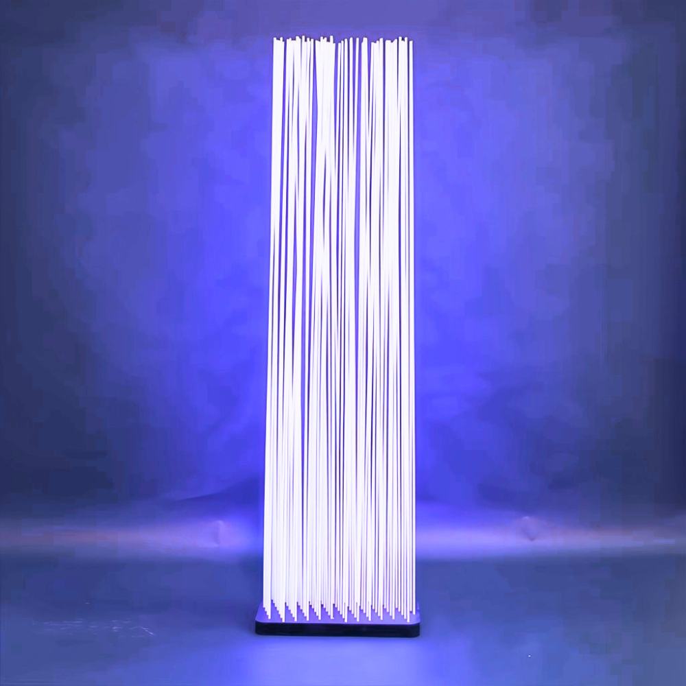 Extremis Sticks in white, a single divider lit from within against a blue wall