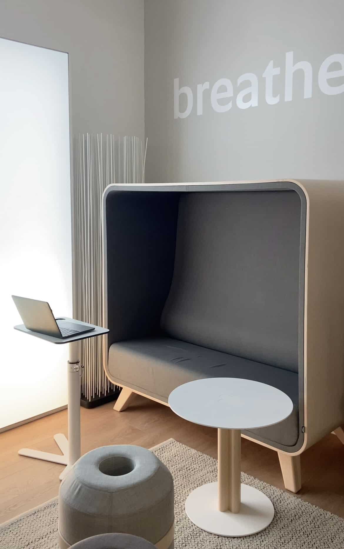 Loook Box Sofa with grey interior and beige outer shell on light wood legs, seen in a showroom