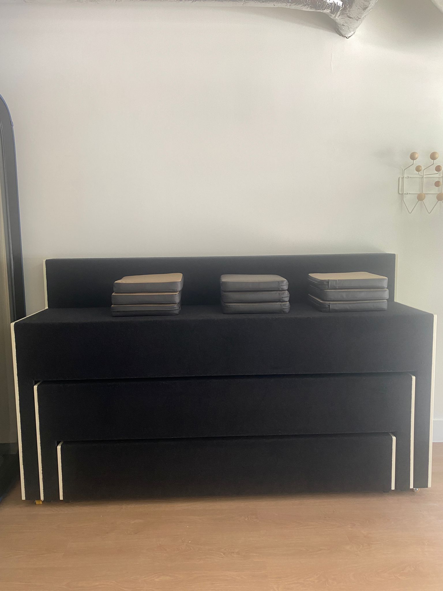 Martela Beatbox Mobile Auditorium closed into a compact bench, with the cushions stacked on top