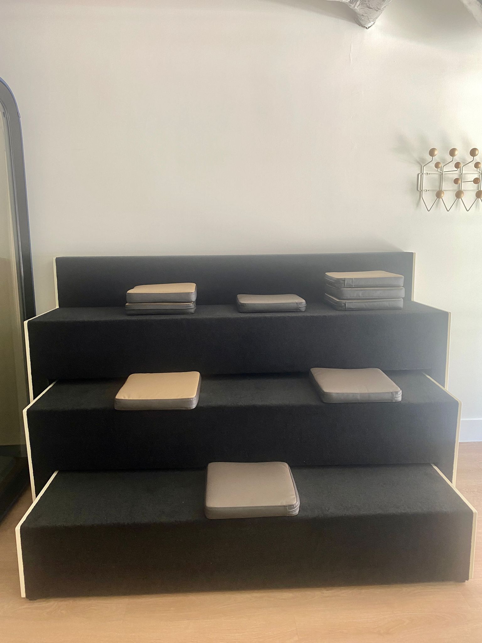 Martela Beatbox Mobile Auditorium in oyster white and black felt, tiers extended with seat cushions in place