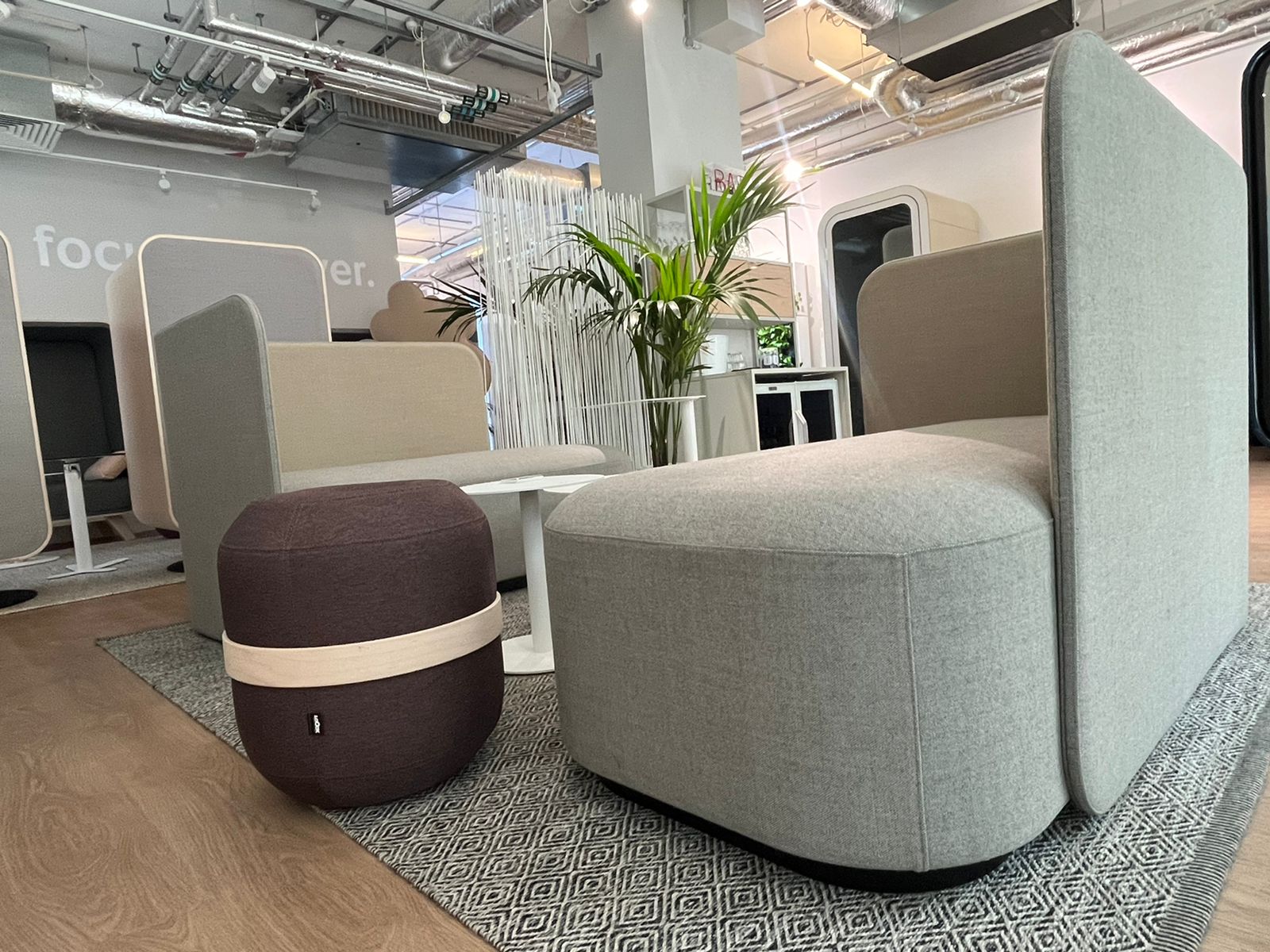 Martela PodLounge Bench with Screen in light grey and beige, seen in a showroom